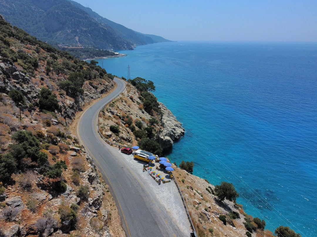 A winding coastal road beside the blue Mediterranean Sea